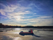 Ice fishing hovercraft resting on frozen lake