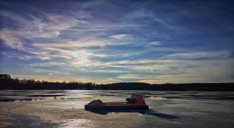 Hovercraft resting on frozen lake after icefishing